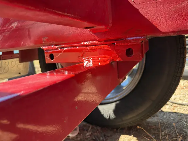 Repaired and painted trailer frame joint at the axle